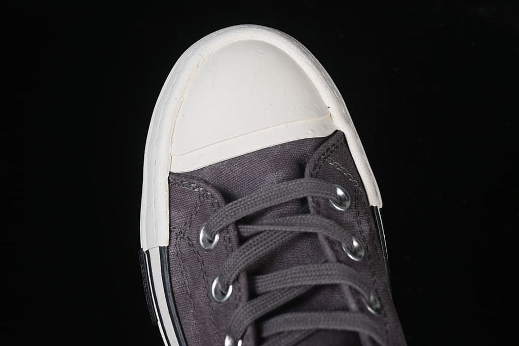 Top-down close-up of the light-colored toe cap and laces.