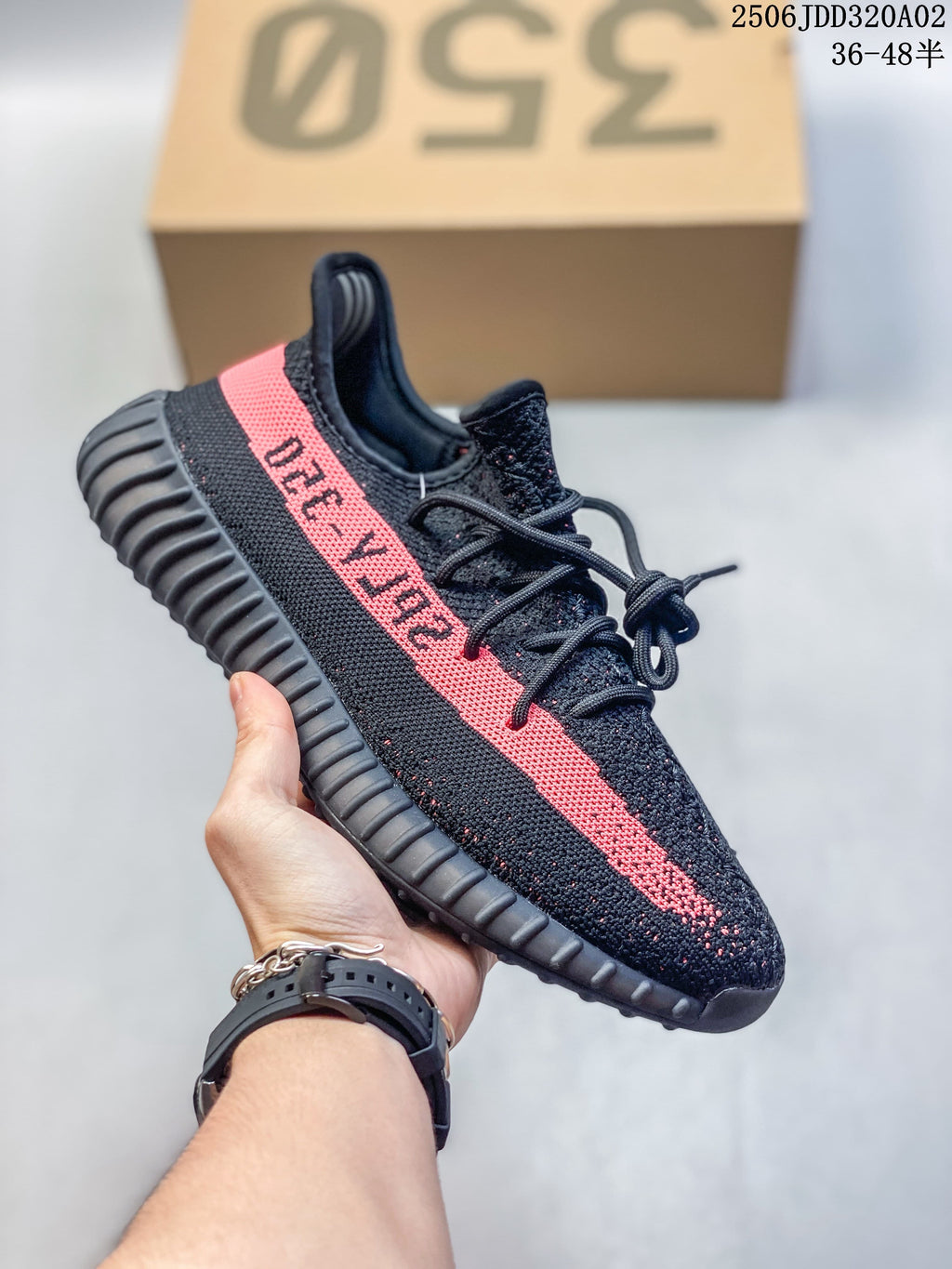 Black Adidas Yeezy-style sneaker with a pink side stripe and ribbed sole