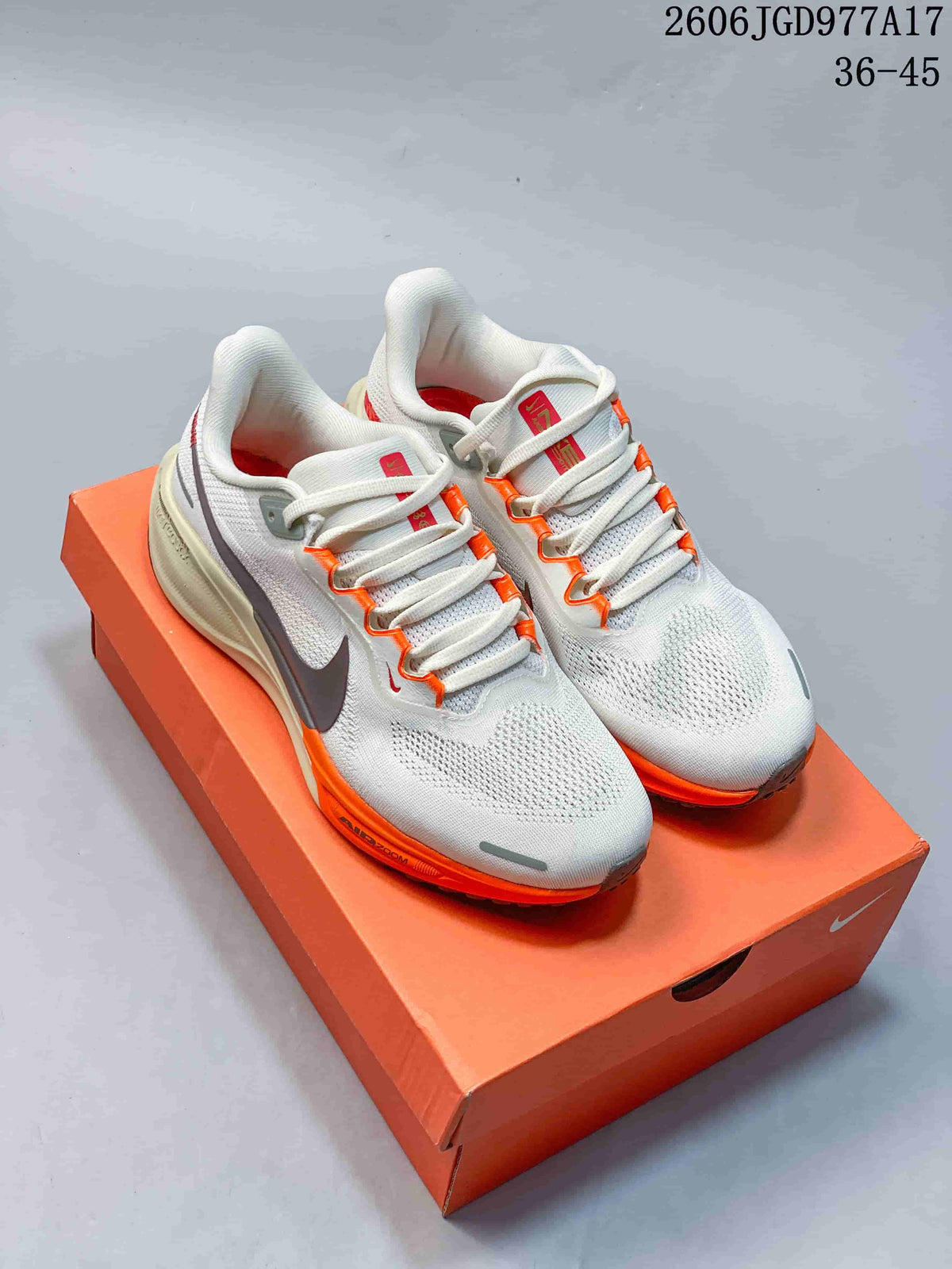 Light Nike Pegasus 41 shoes with orange accents and dark Swooshes on an orange shoe box