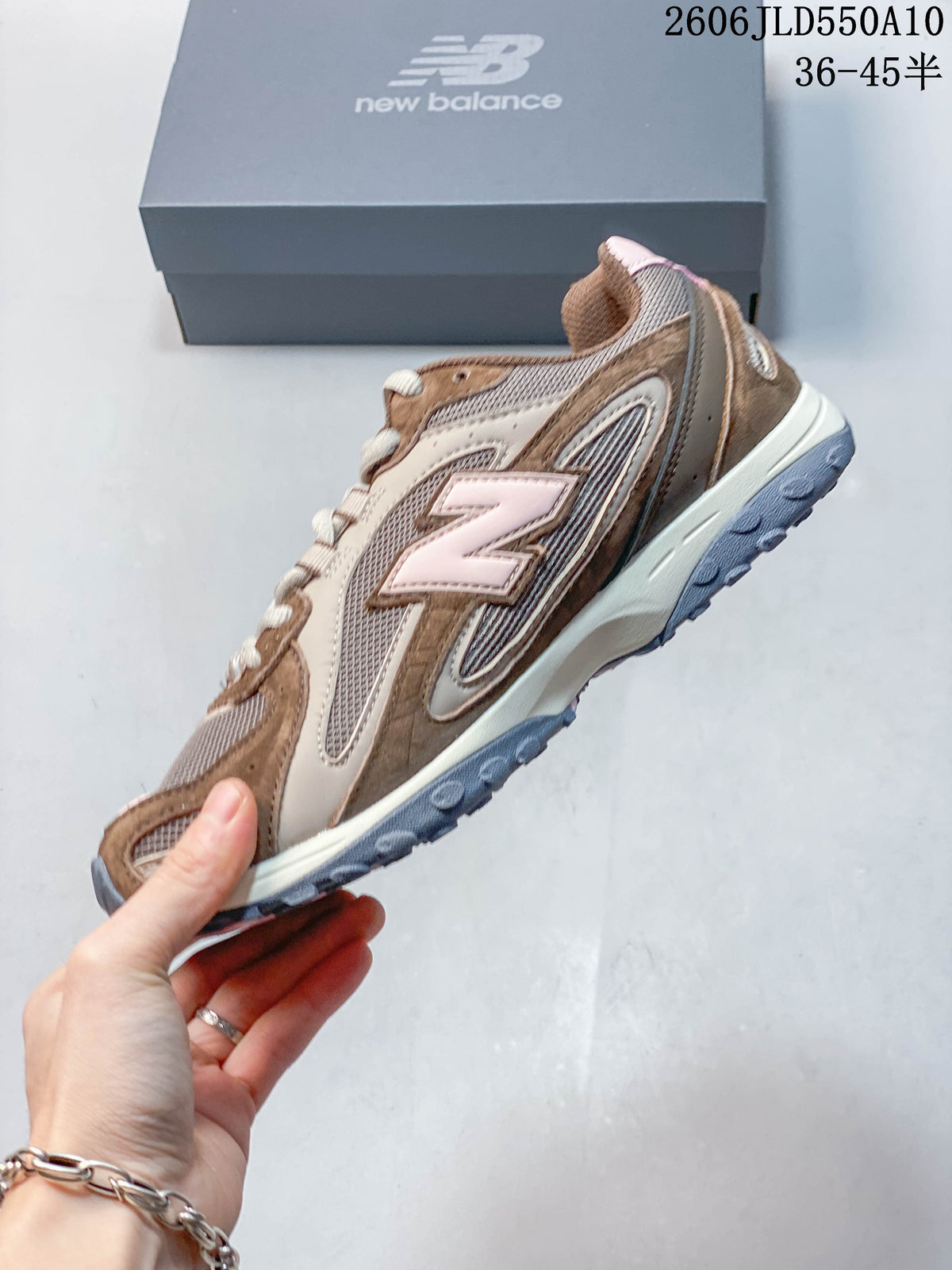 Side view of a brown, beige, and pink New Balance 204L sneaker