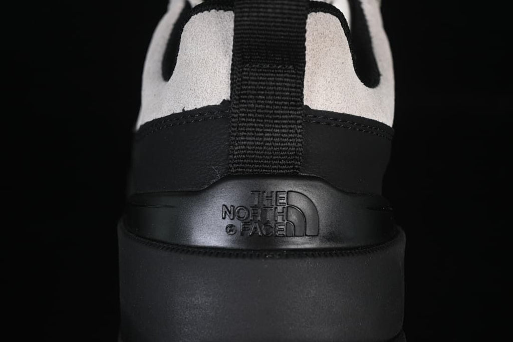 Rear close-up of black heel panel, pull tab and embossed logo