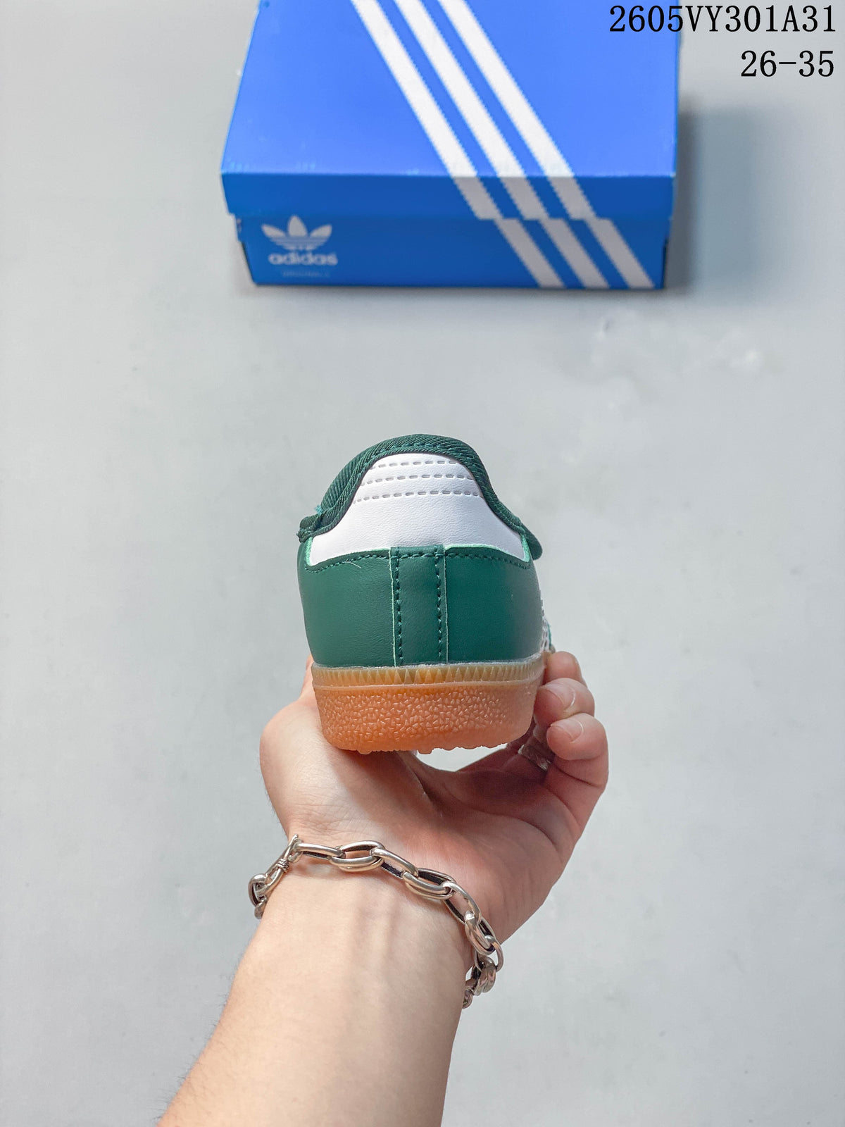 Rear view of the green and white kids' shoe with gum-colored sole