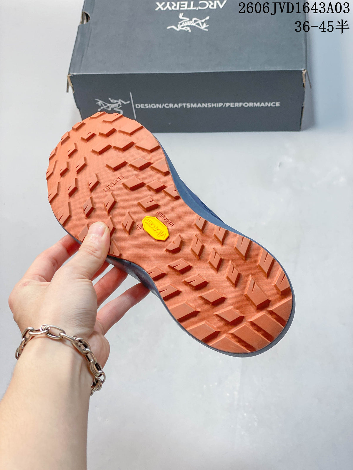 Close-up of the orange lugged outsole with Vibram marking