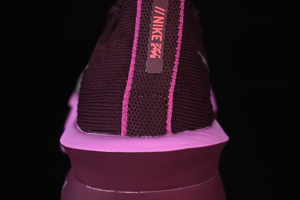 Rear view of the shoe showing pink trim and a burgundy heel