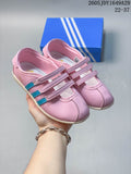 Pink three-strap sneakers shown from above with contrasting blue side stripes.