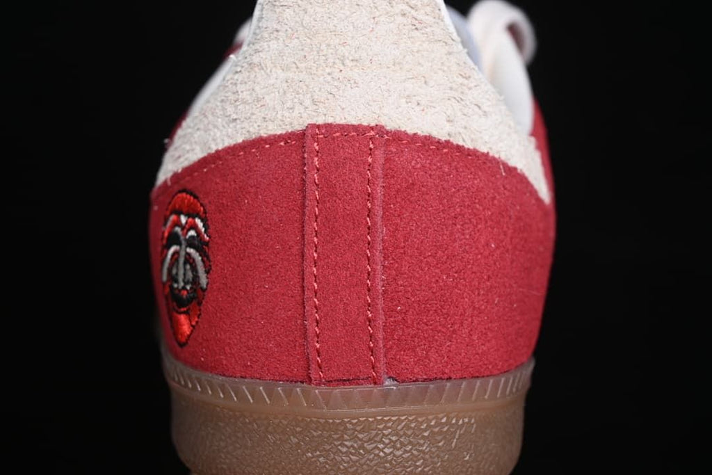 Rear close-up of the red heel panel, light-colored heel tab, and gum outsole.
