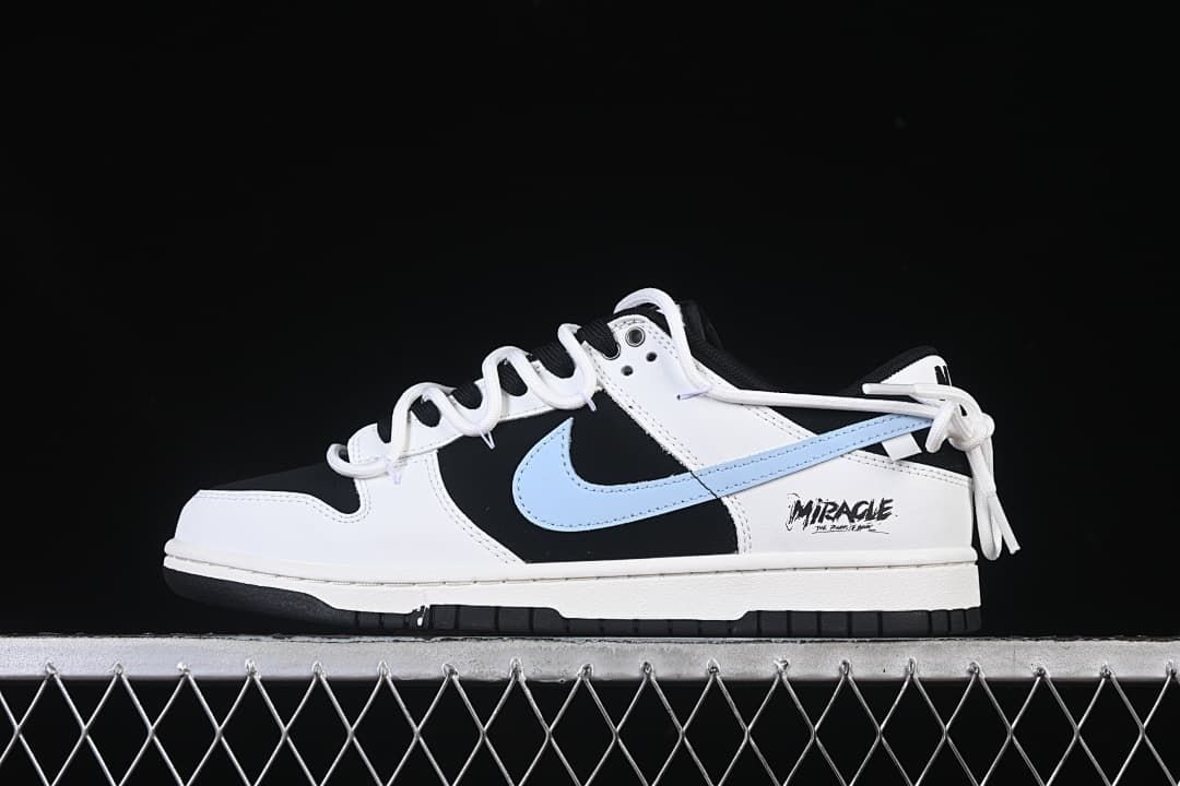 Side view of black and white Nike Dunk Low sneakers with a light blue Swoosh and Miracle heel graphic