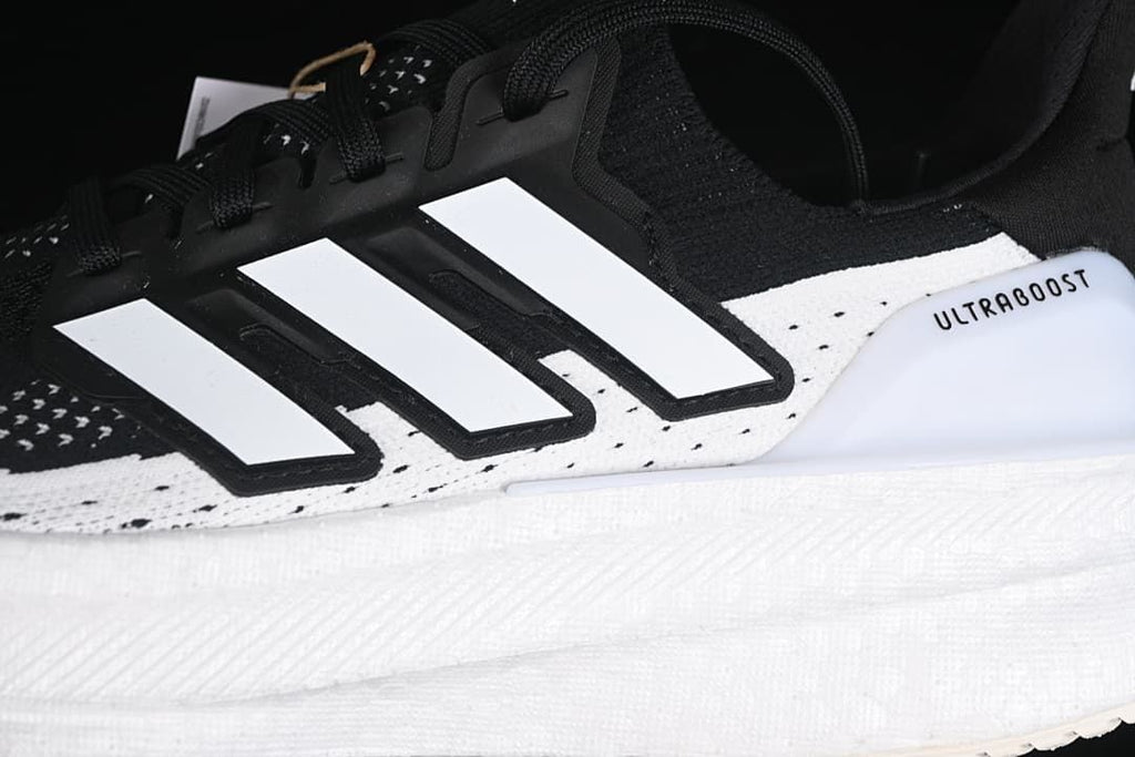 Close-up of the black and white side stripes and Ultraboost detail
