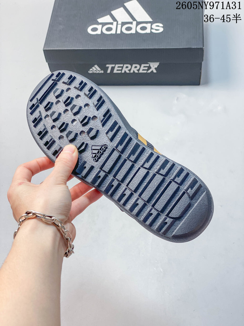 Close-up of the patterned outsole on a dark gray outdoor shoe