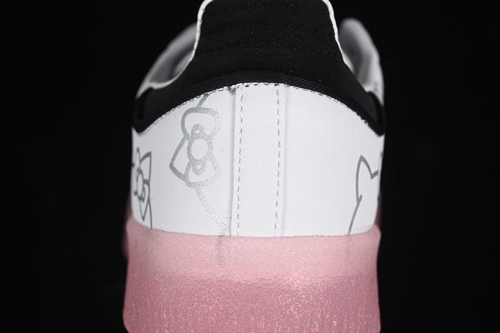 Rear close-up of the sneaker showing Hello Kitty line art, black heel detail, and pink sole.