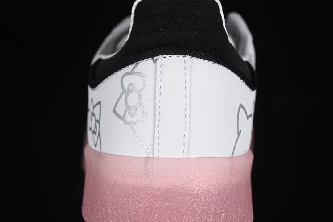 Rear close-up of the sneaker showing Hello Kitty line art, black heel detail, and pink sole.