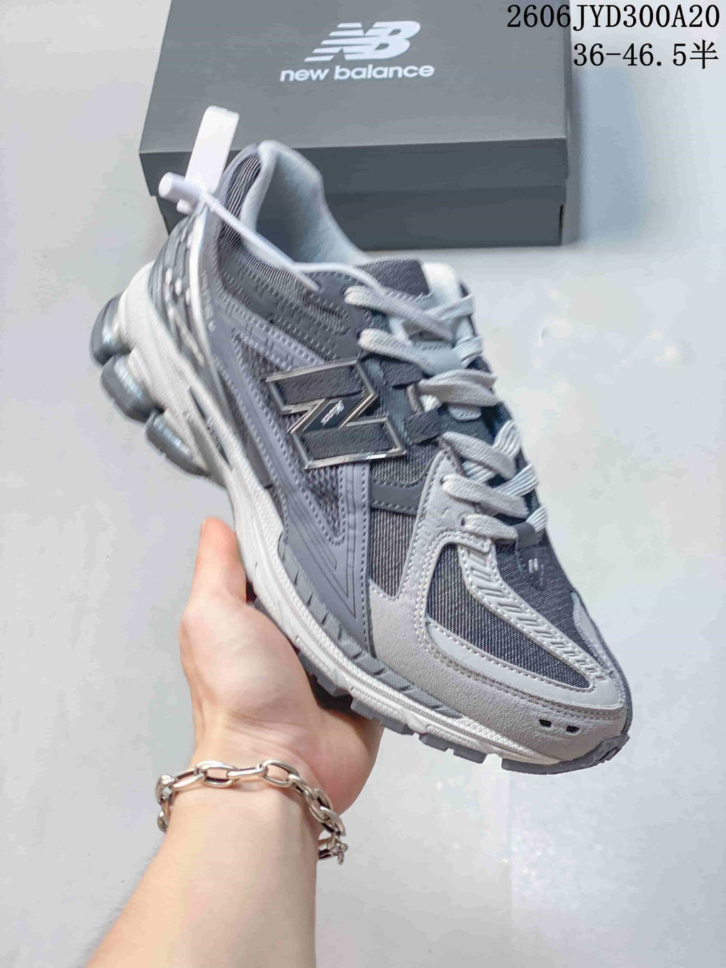 Angled side view of a grey New Balance 1906 sneaker