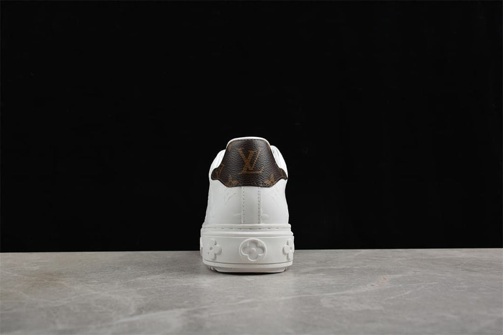 Rear view of the sneaker showing the brown patterned heel panel and raised sole
