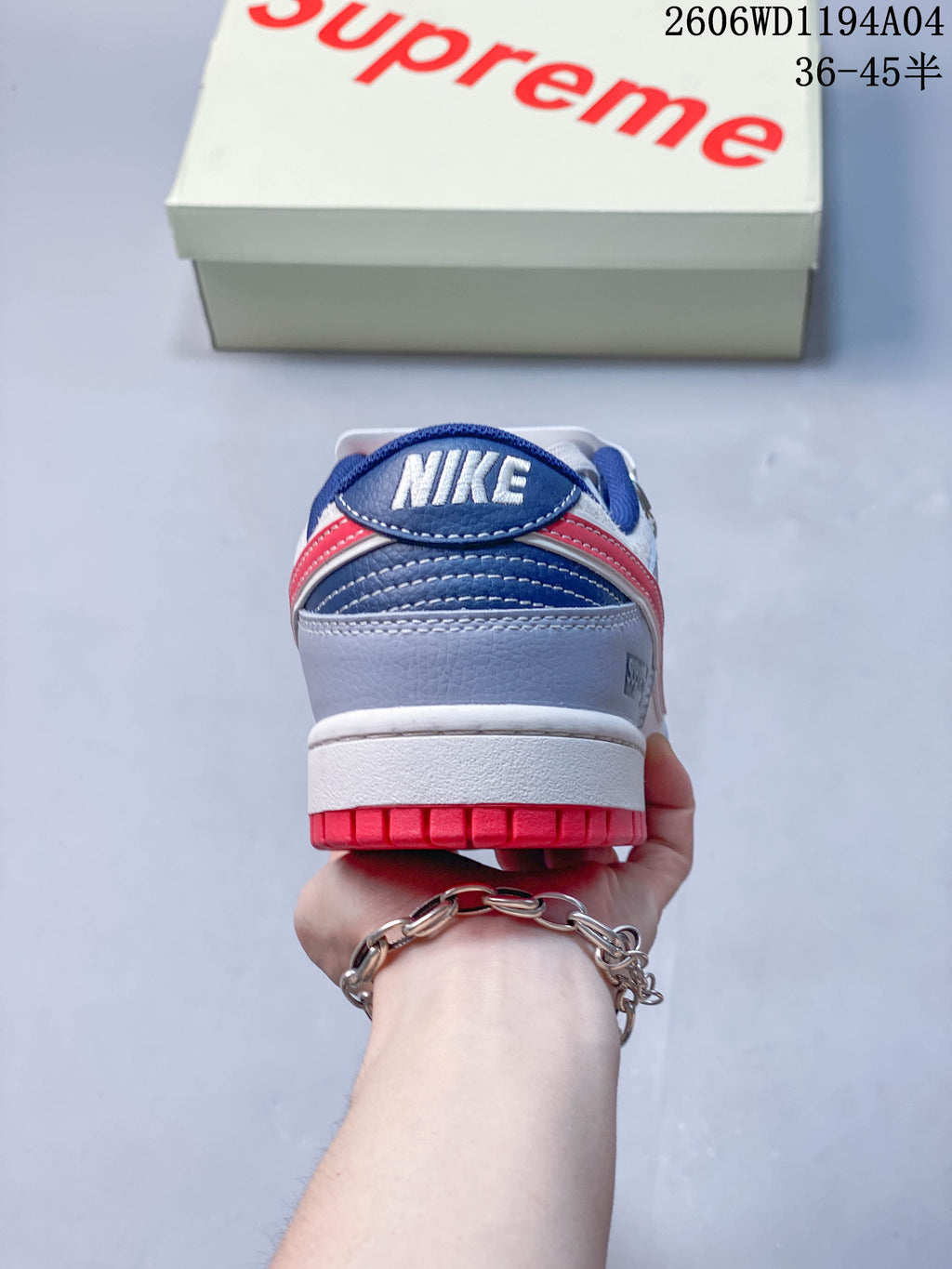 Rear view showing the blue heel panel and red outsole