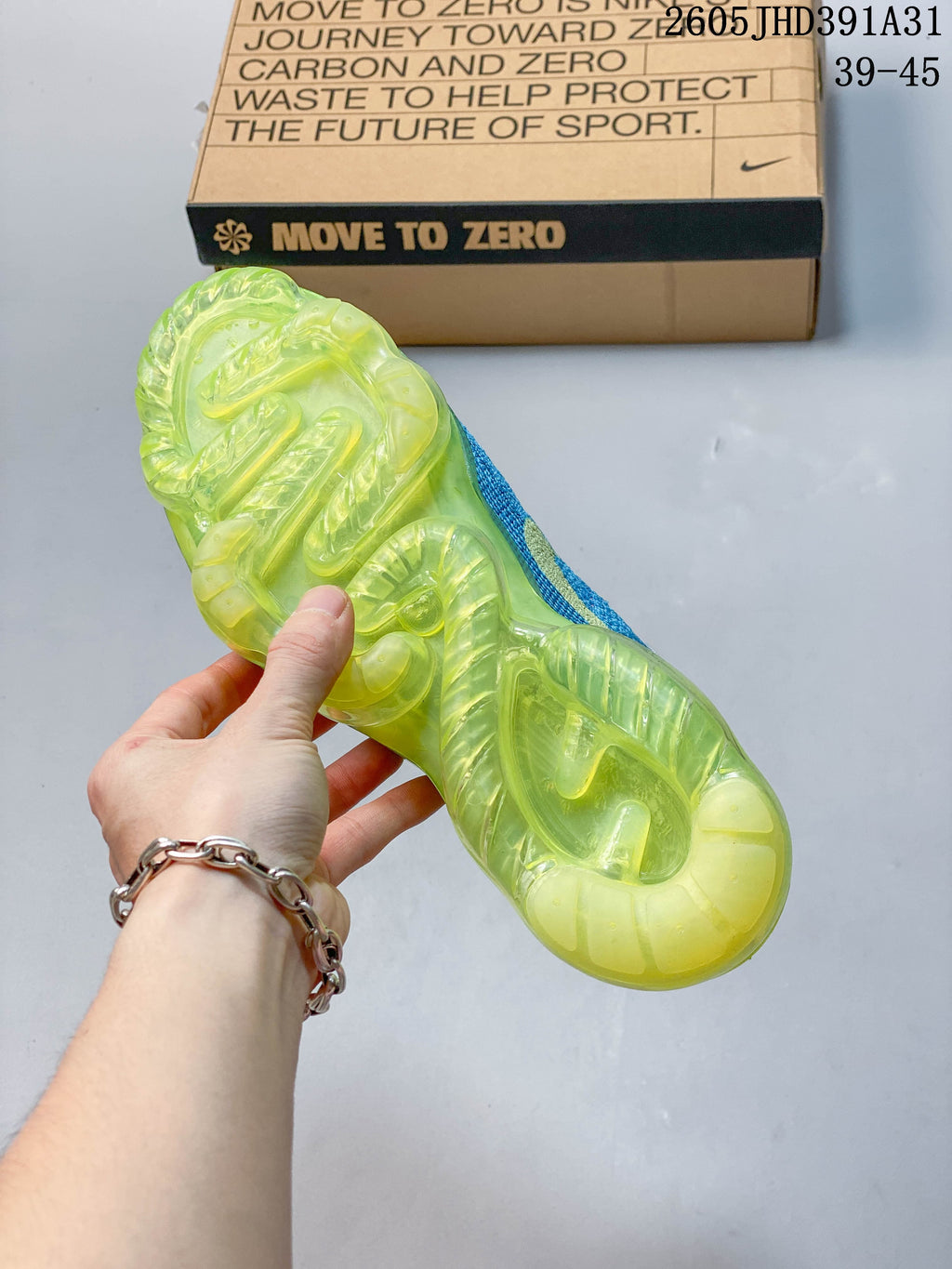 Underside of a shoe showing the translucent lime-green sole unit