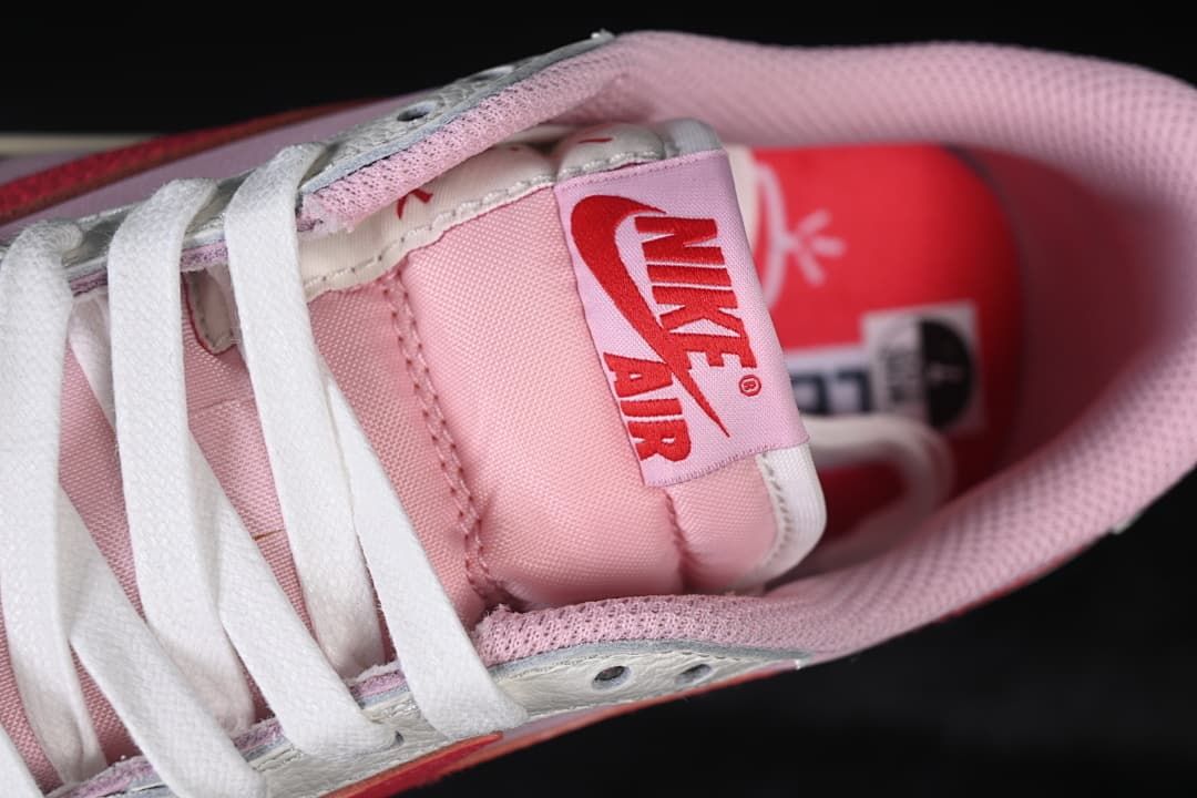 Close-up of the tongue label, white laces, and pink lining.