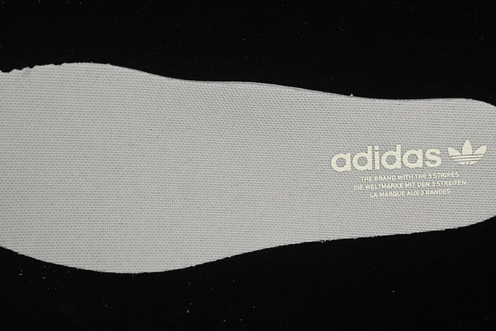 Light-colored insole printed with adidas Trefoil branding