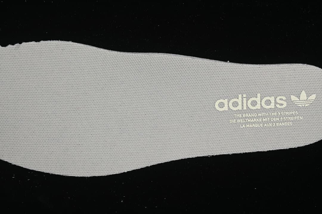 Light-colored insole printed with adidas Trefoil branding