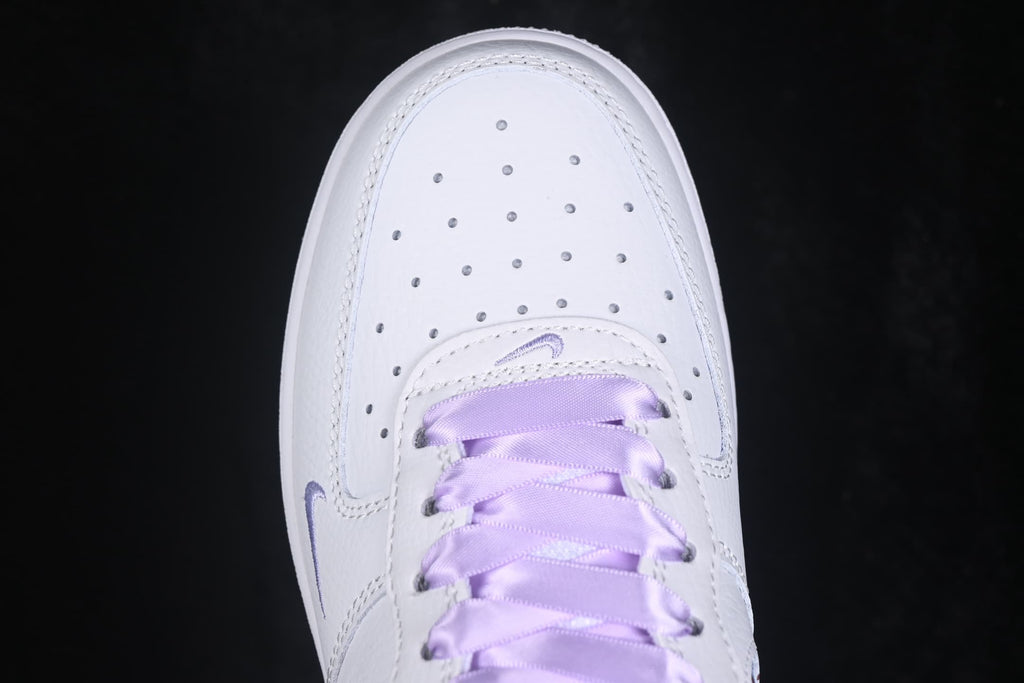 Top view showing the perforated white toe box and lavender laces.