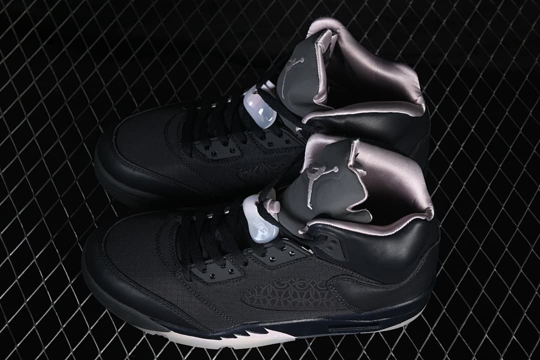 Pair of black Air Jordan 5 PSG sneakers viewed from above and the side
