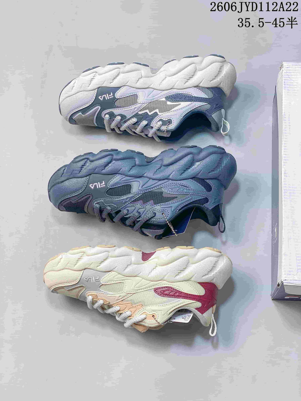 Three color options of FILA sneakers shown from the side: light gray, gray-blue, and cream.