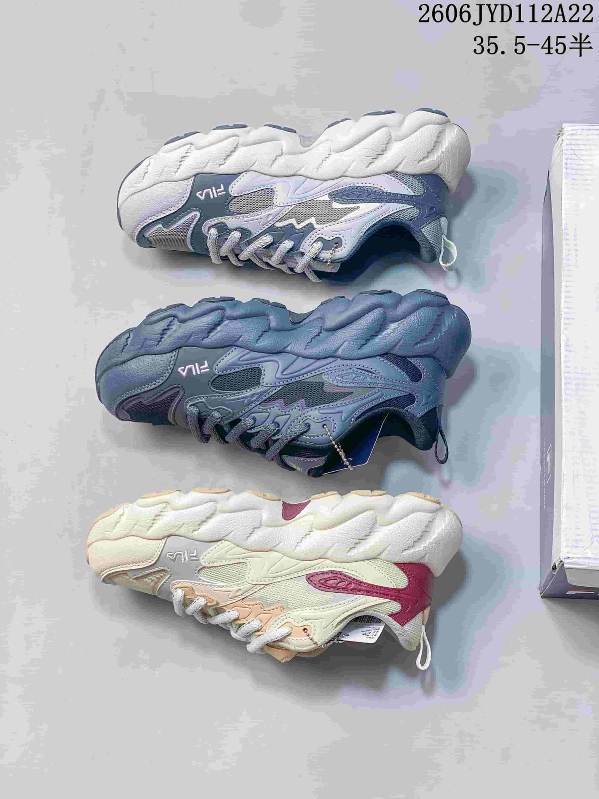Three color options of FILA sneakers shown from the side: light gray, gray-blue, and cream.