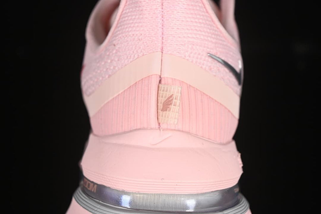 Rear view of the pink shoe showing the heel and visible cushioning unit