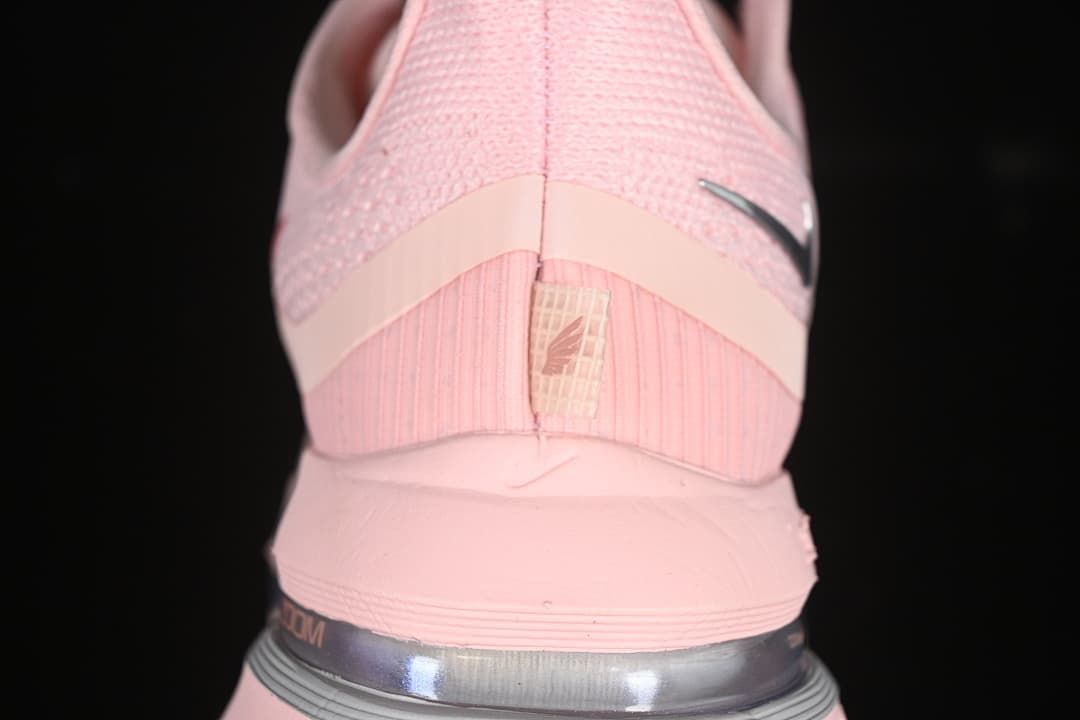 Rear view of the pink shoe showing the heel and visible cushioning unit
