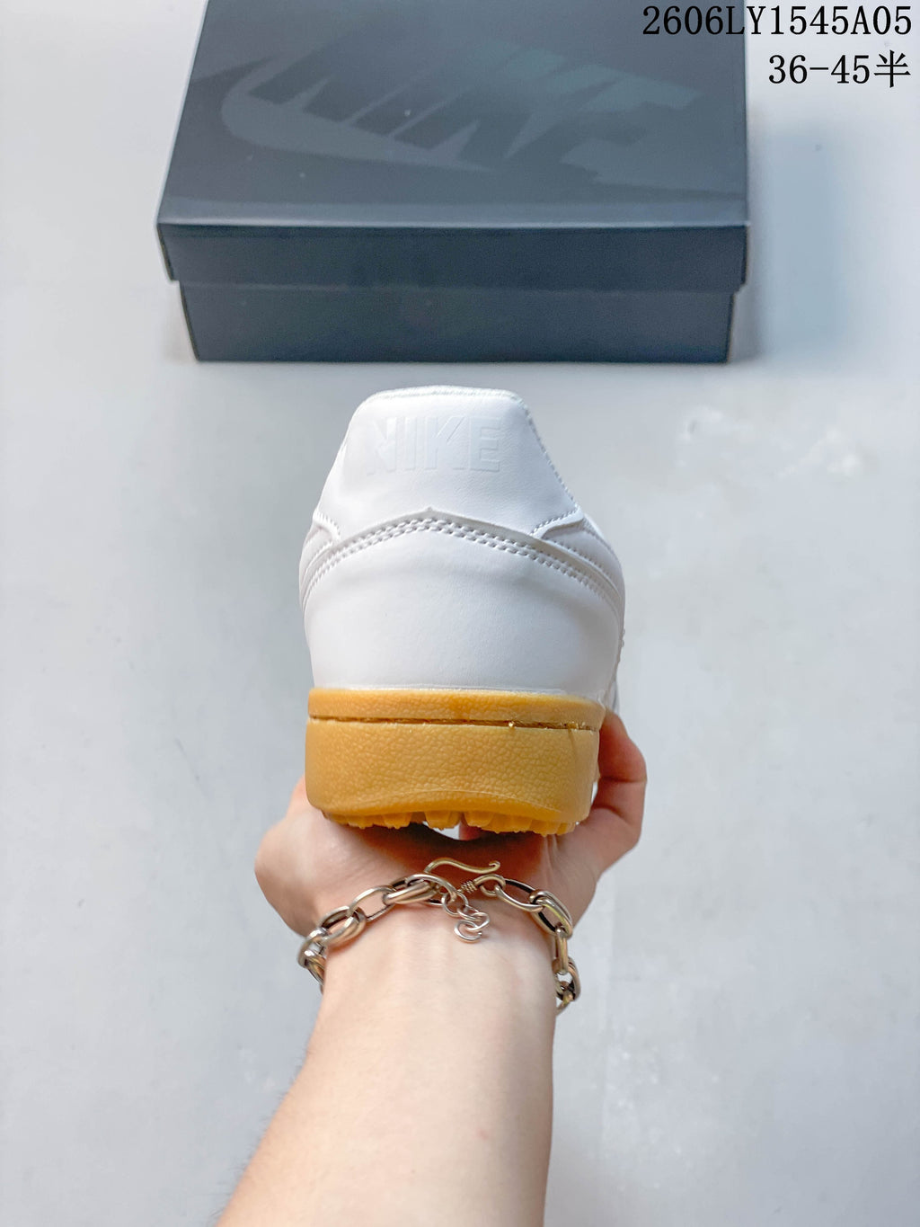 Rear view of a white Nike Field General sneaker showing the gum-colored heel and outsole.