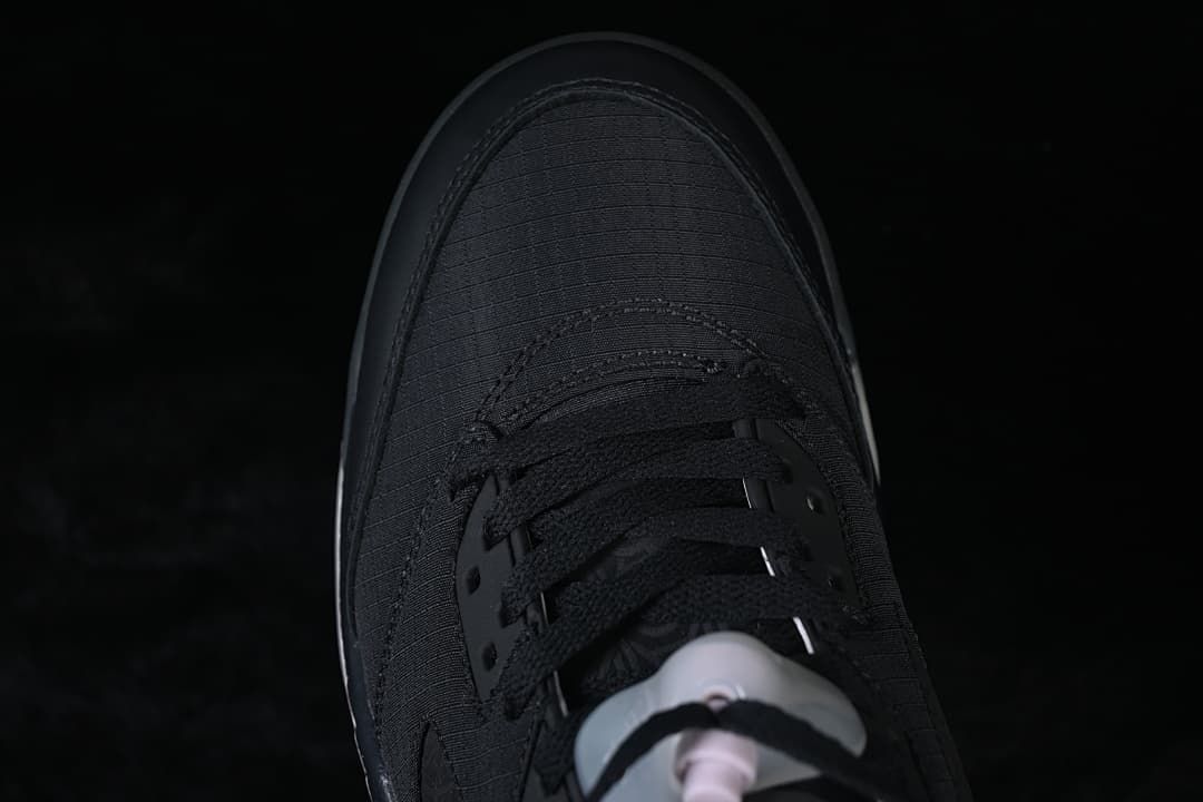 Top-down view of the black sneaker's toe and laces