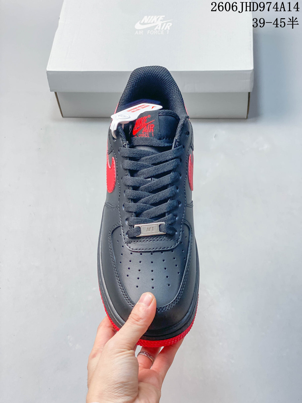 Front view of a navy low-top sneaker with perforated toe and lace tag