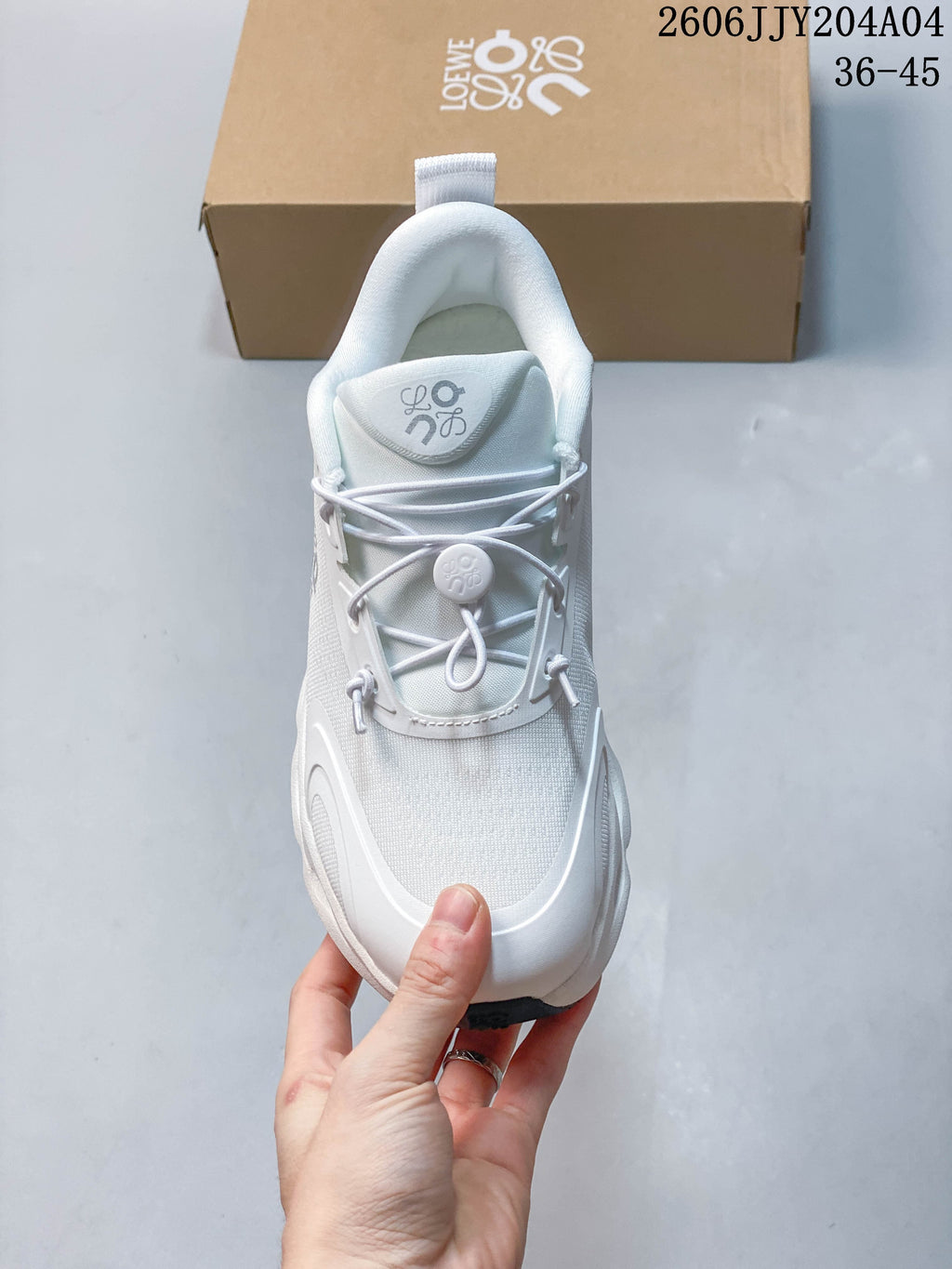 Top view of a white sneaker with elastic toggle lacing