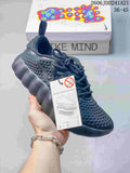 Navy Nike Mind 002 SP FK shoe with a thick white sculpted outsole, shown beside its box.