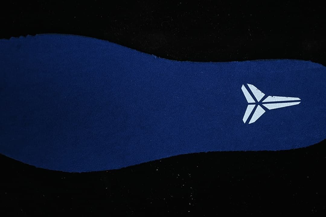 Close-up of a blue shoe insert with a Kobe logo