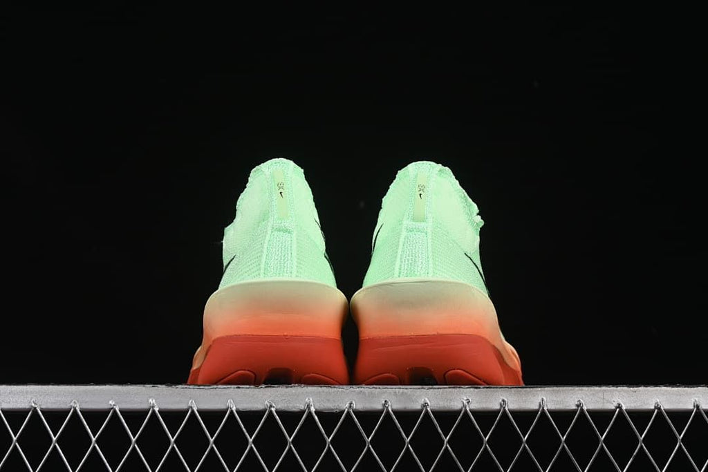 Rear view of both shoes and their coral-toned outsoles