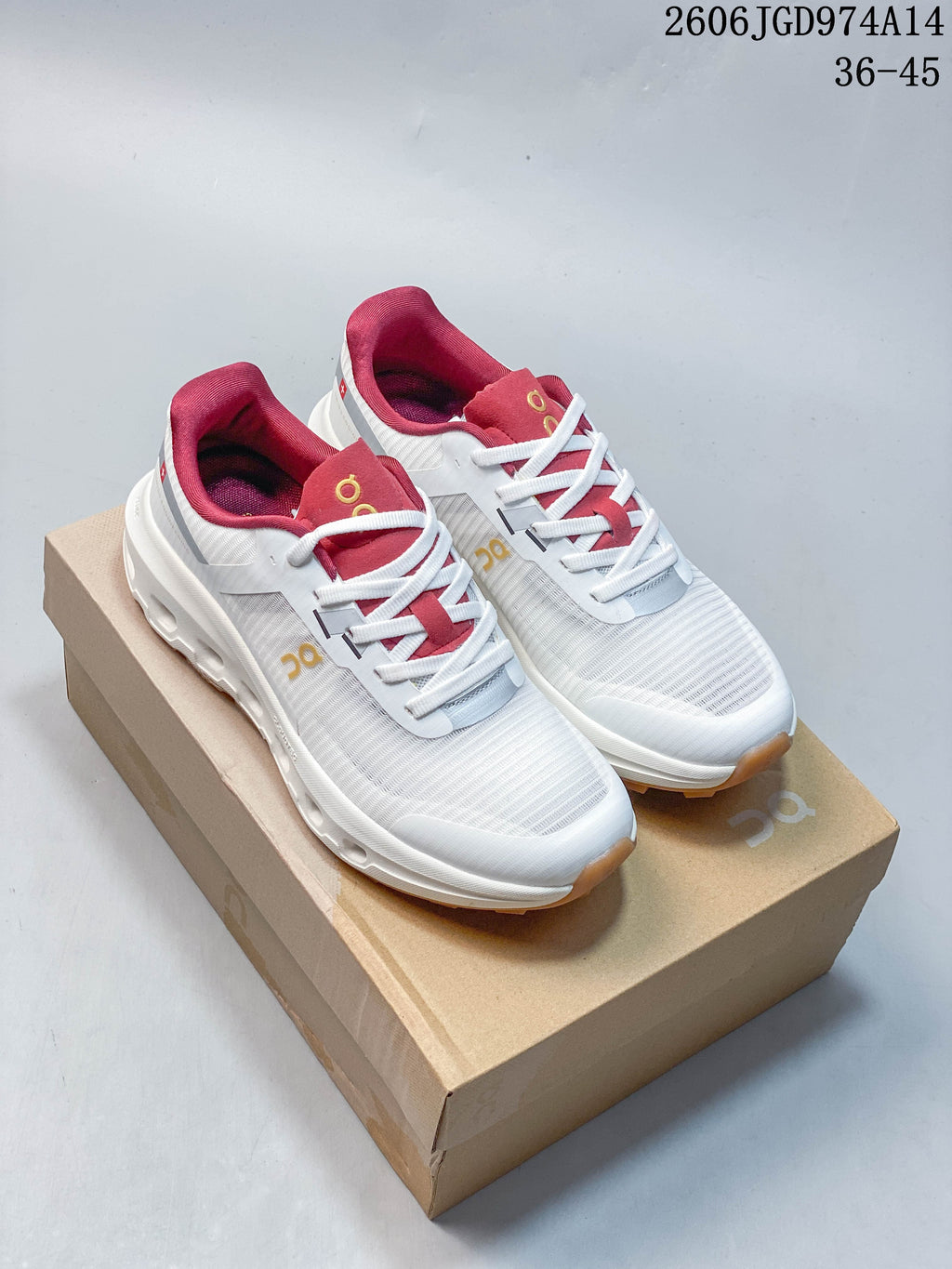 Pair of white On Cloudvista 2 trail running shoes with pink accents and gum-colored outsoles, shown on a shoebox.