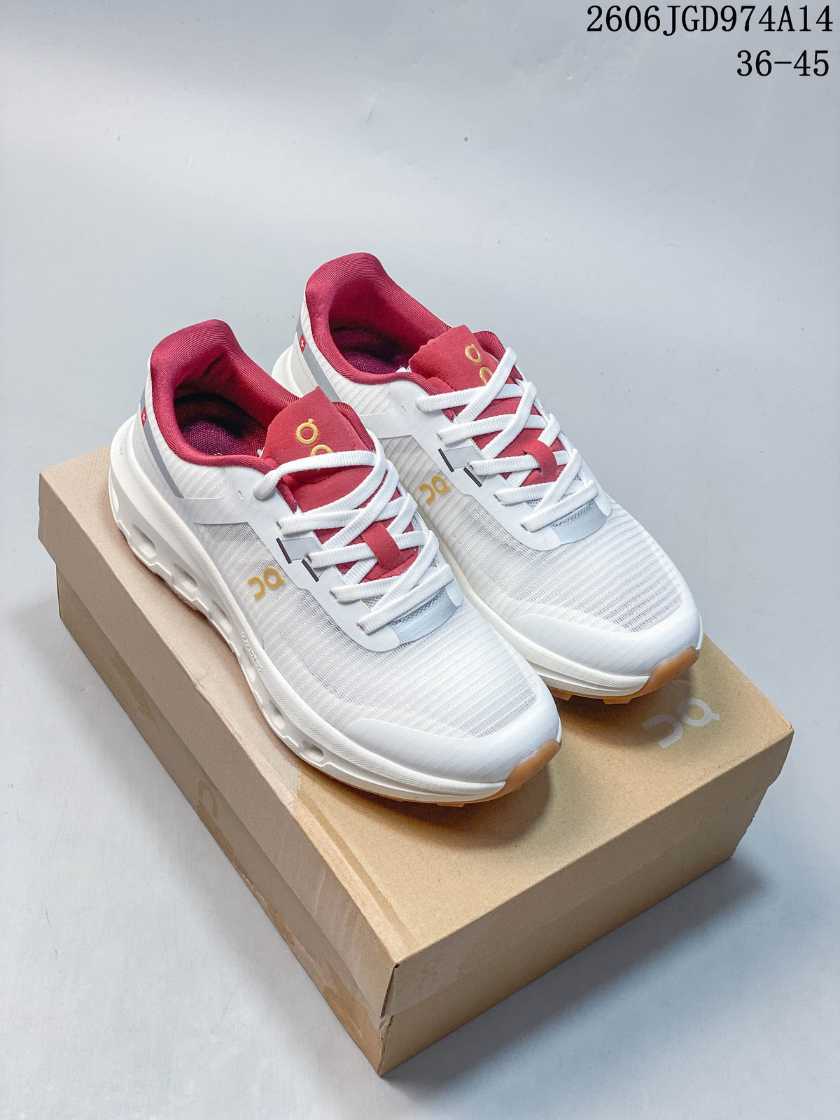 Pair of white On Cloudvista 2 trail running shoes with pink accents and gum-colored outsoles, shown on a shoebox.