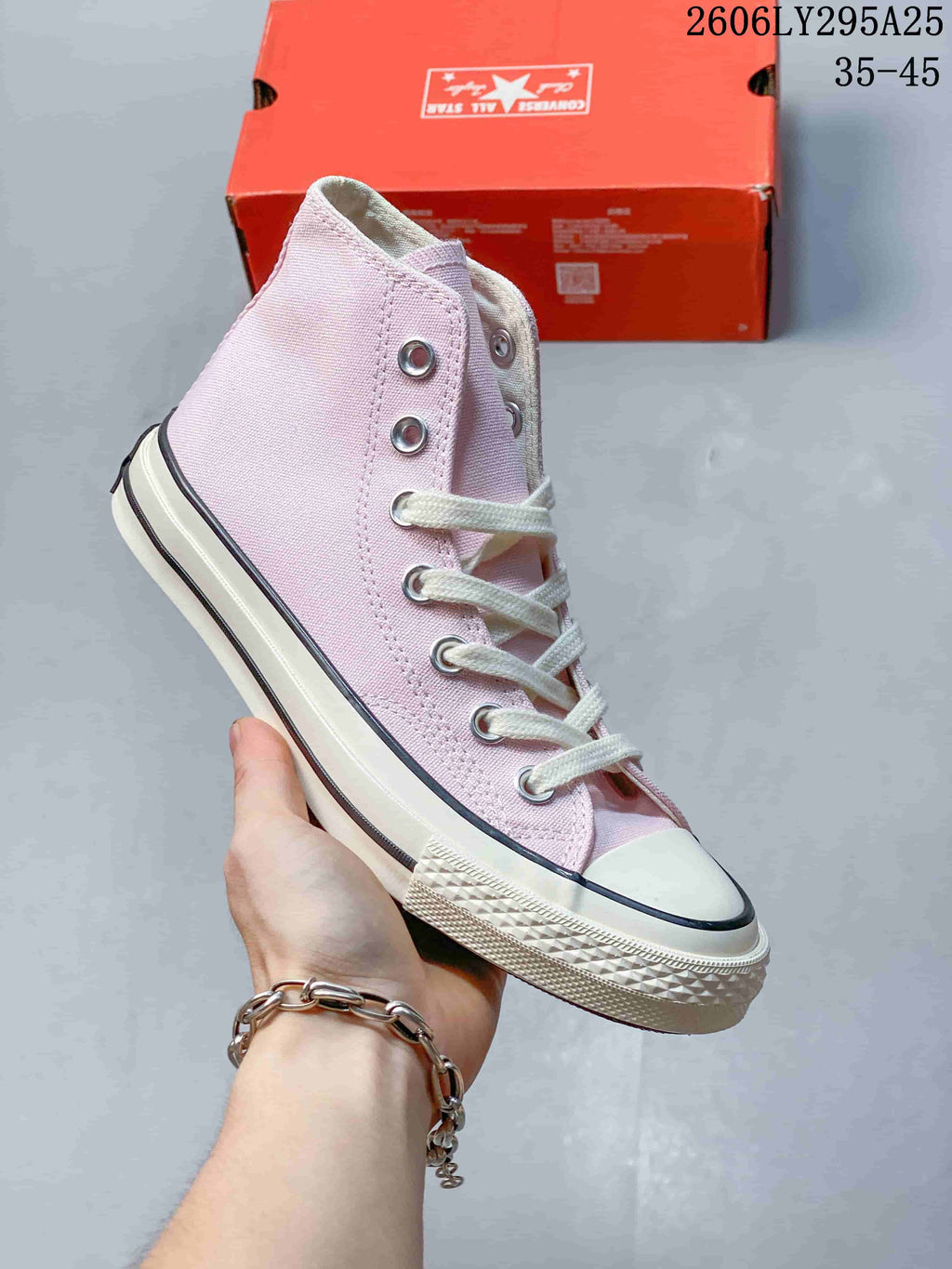 Light pink Converse Chuck Taylor All Star high-top sneaker with white laces; image also displays size range 35–45.