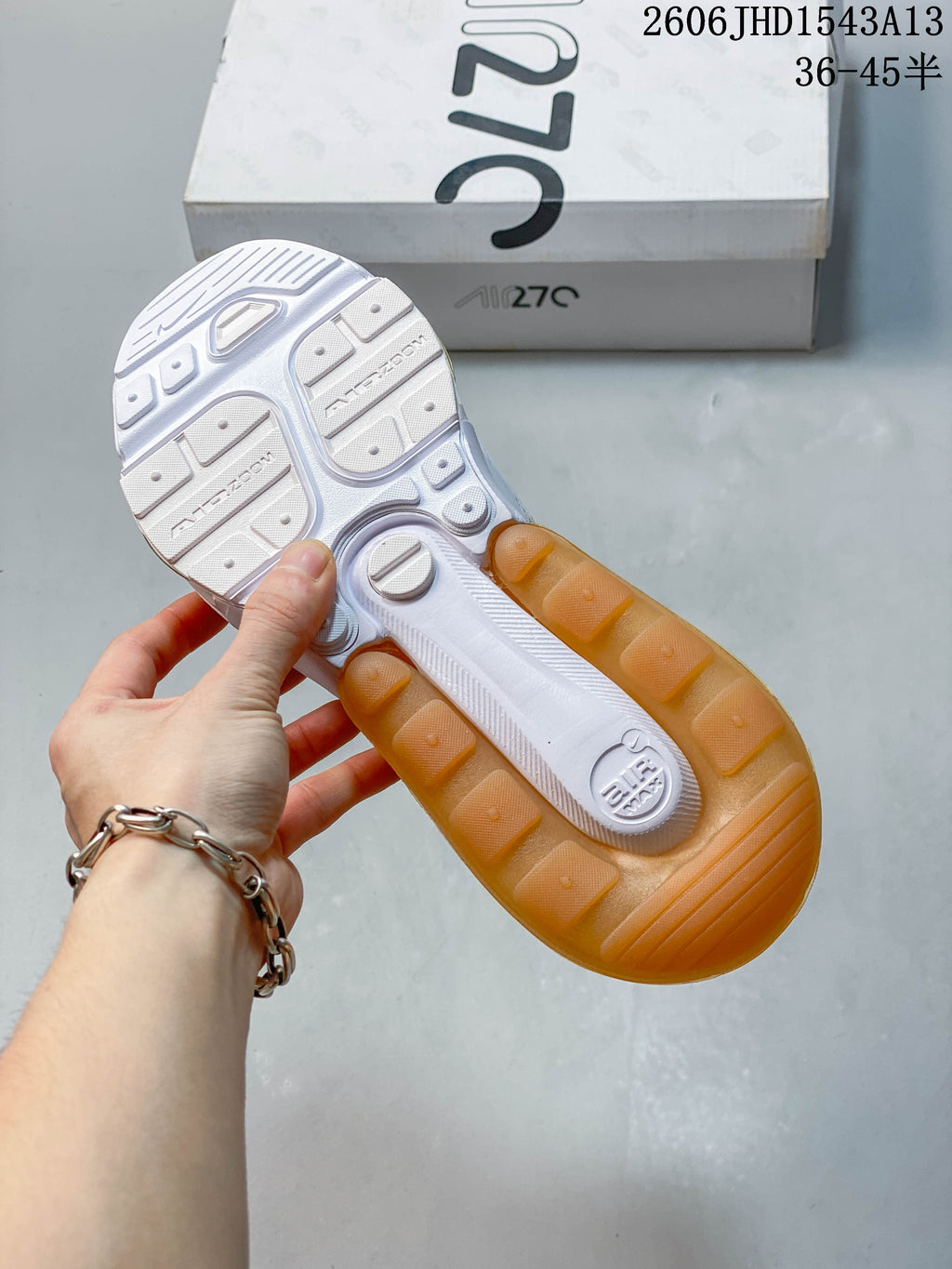 Outsole of a Nike Air Max 270 sneaker showing amber-colored heel sections