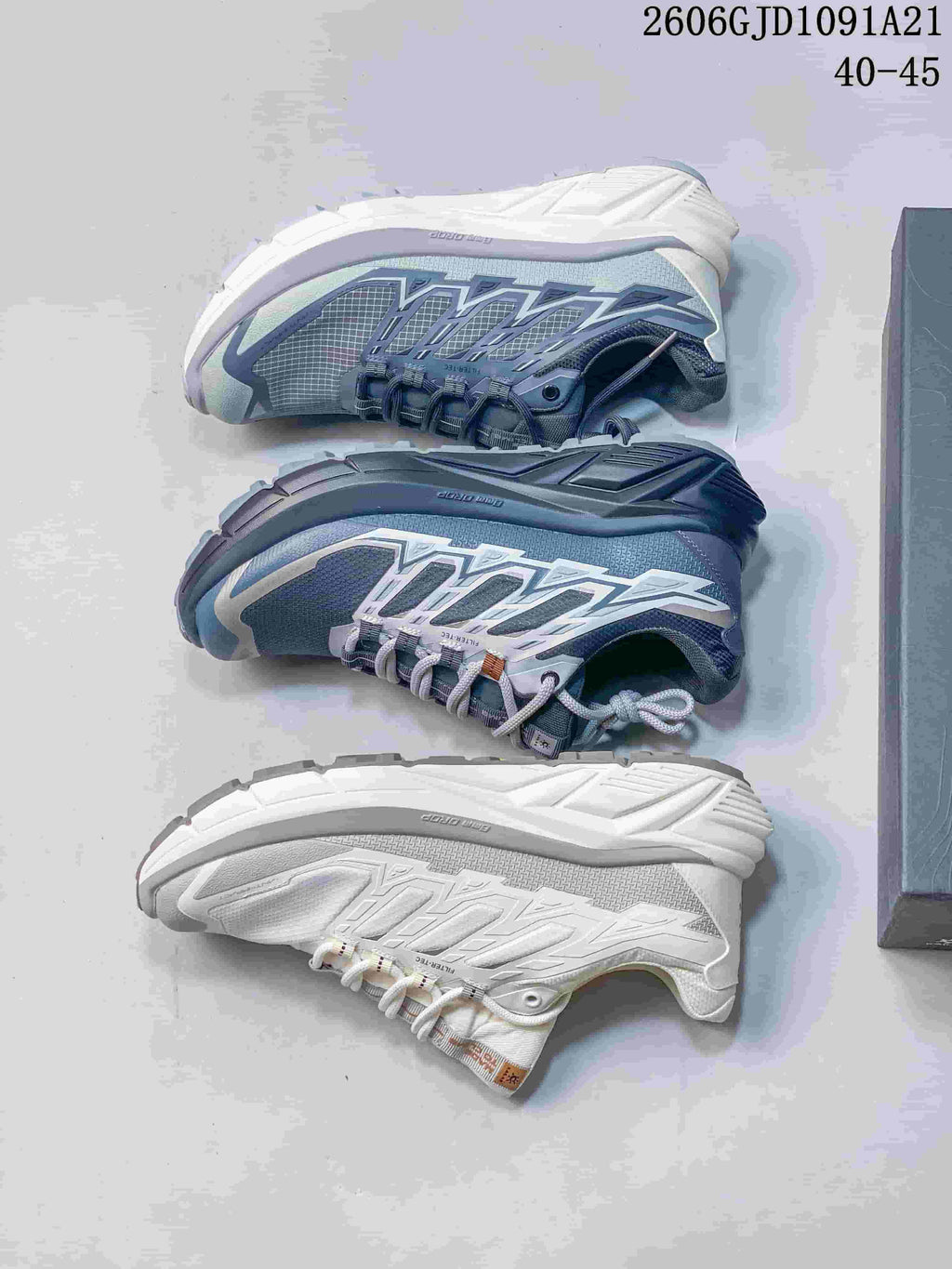 Three KAILAS trail shoes shown from above and side, in blue-gray and white colorways.