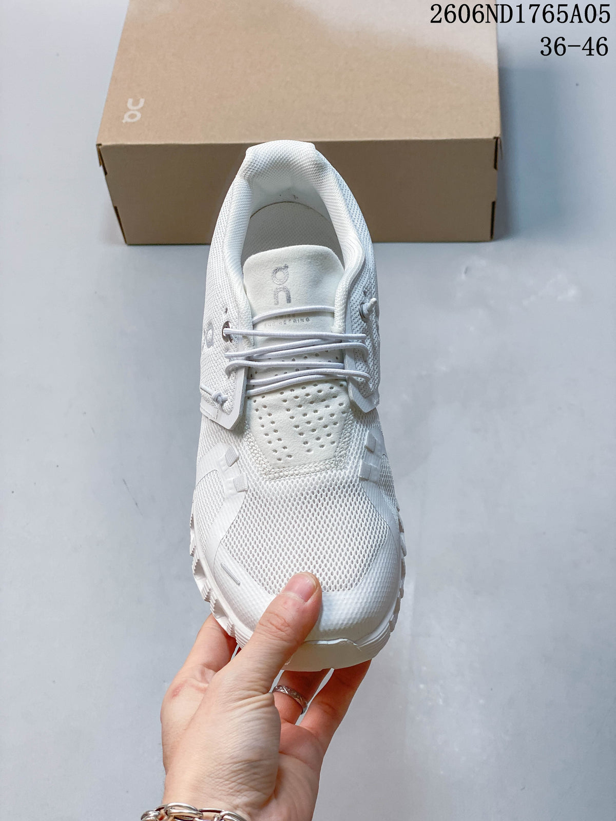 Front view of a white On Cloud 5 sneaker with perforated tongue panel and lace loops