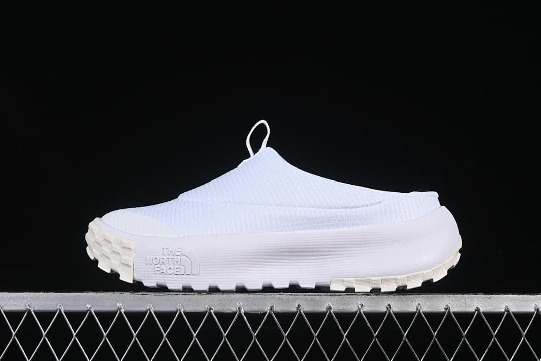 Side view of a white The North Face slip-on sneaker mule