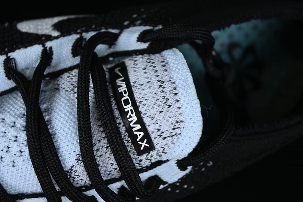 Close-up of the VaporMax tongue label, laces, and knit pattern.
