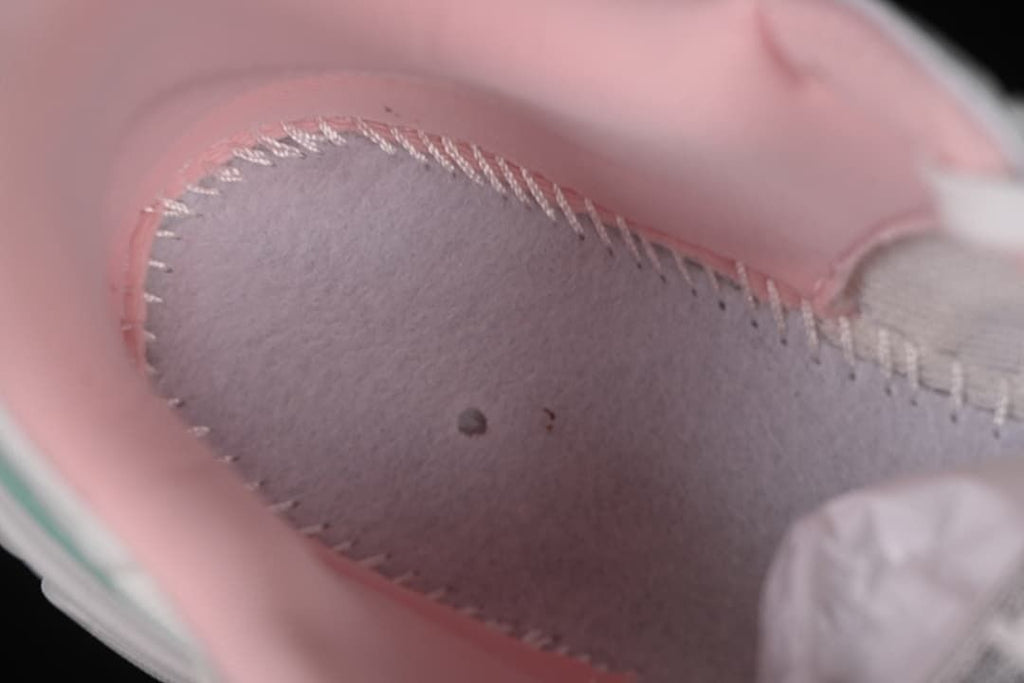 Close-up of the pink padded interior and stitching