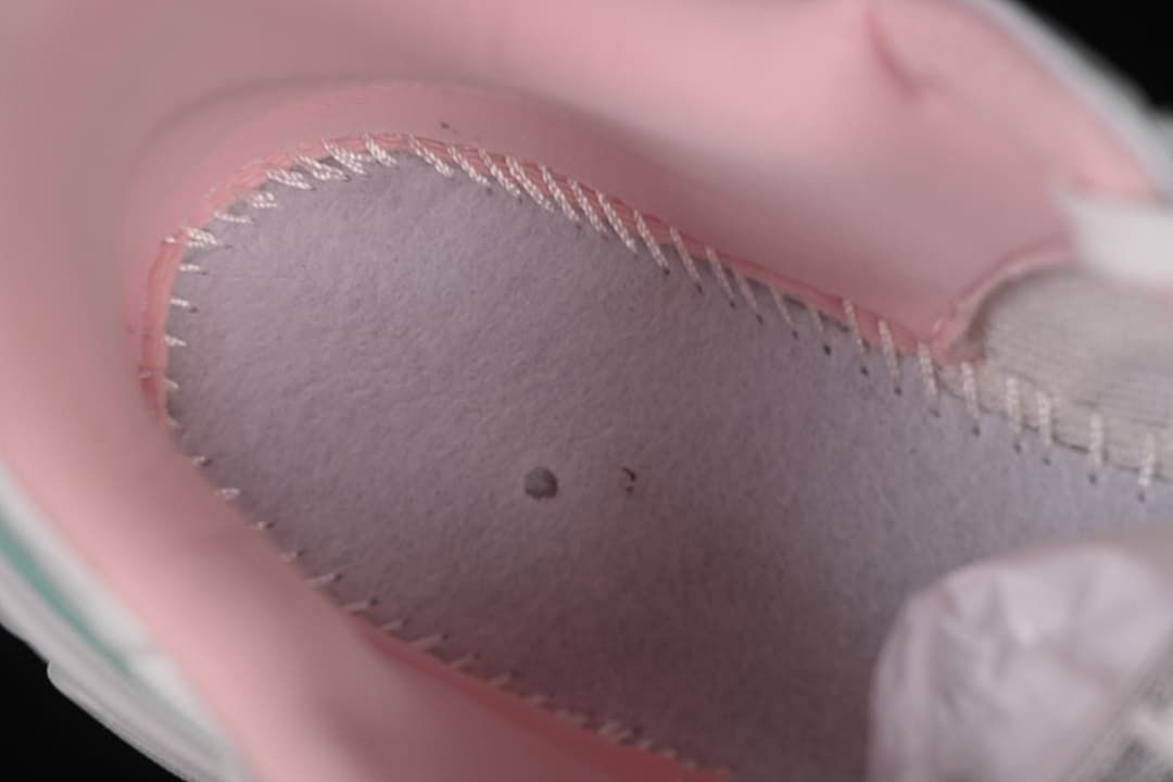 Close-up of the pink padded interior and stitching