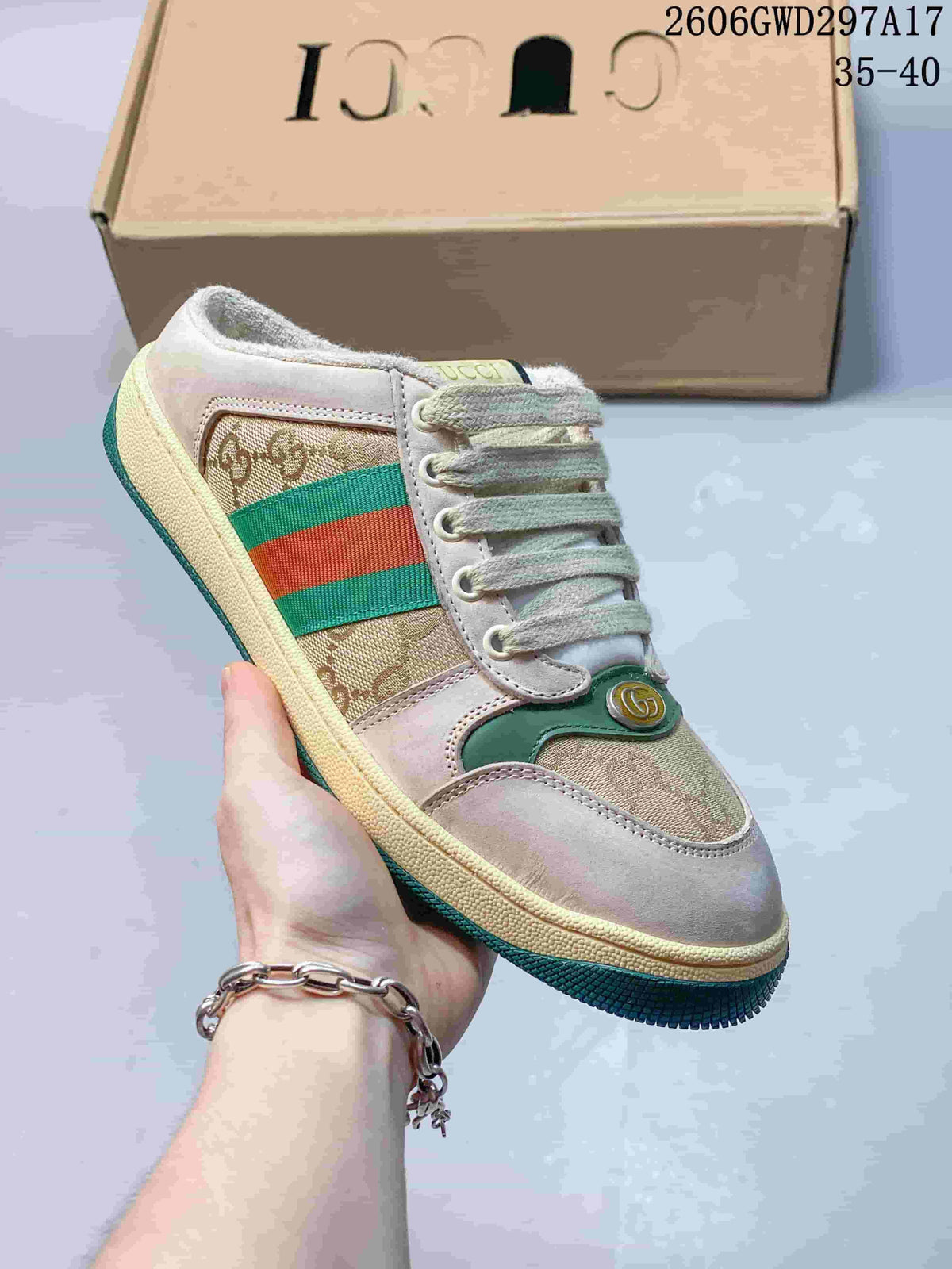 Angled view of the beige and brown patterned mule sneaker with dark green outsole