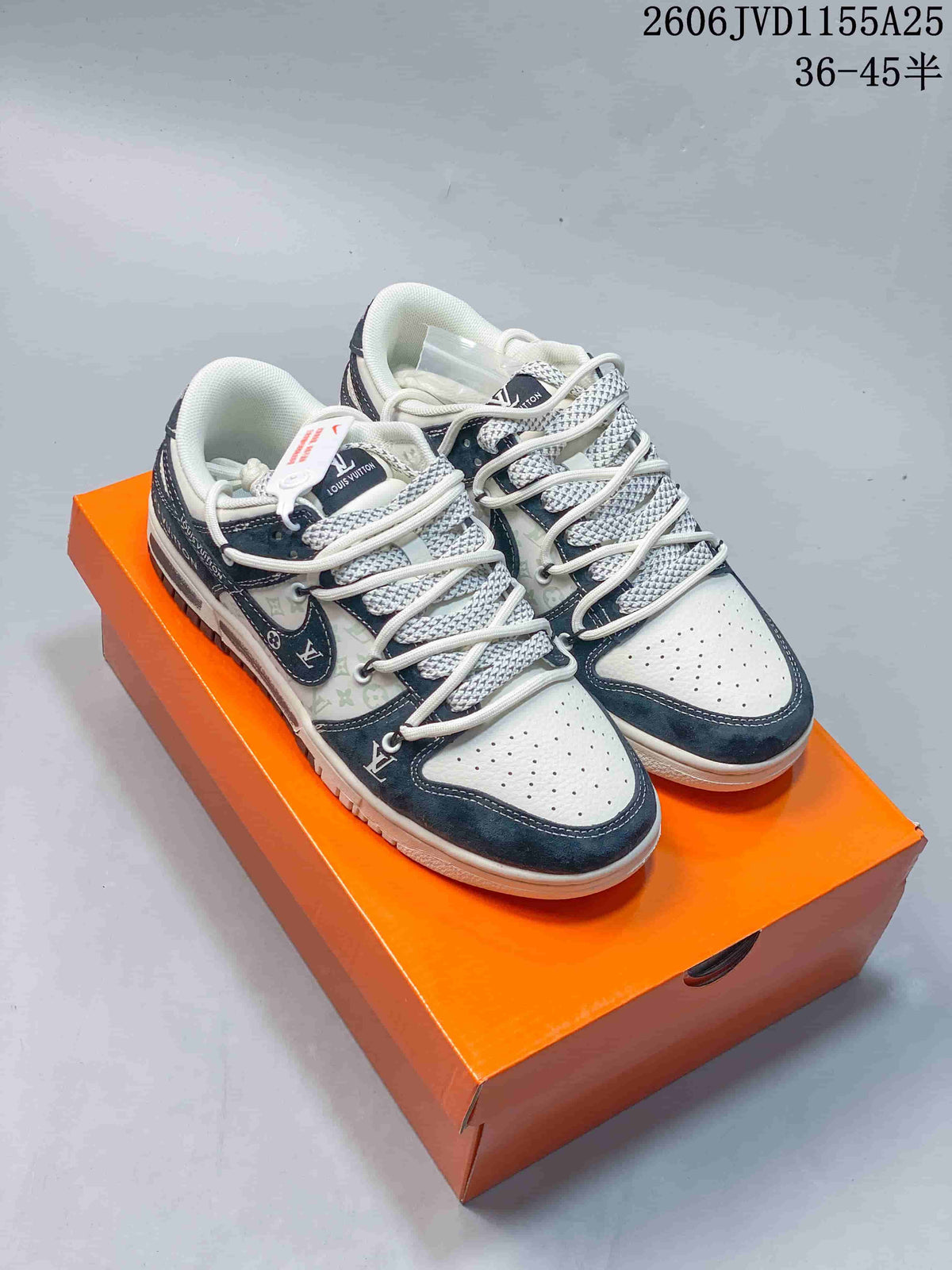 Pair of white low-top sneakers with dark navy overlays and patterned laces