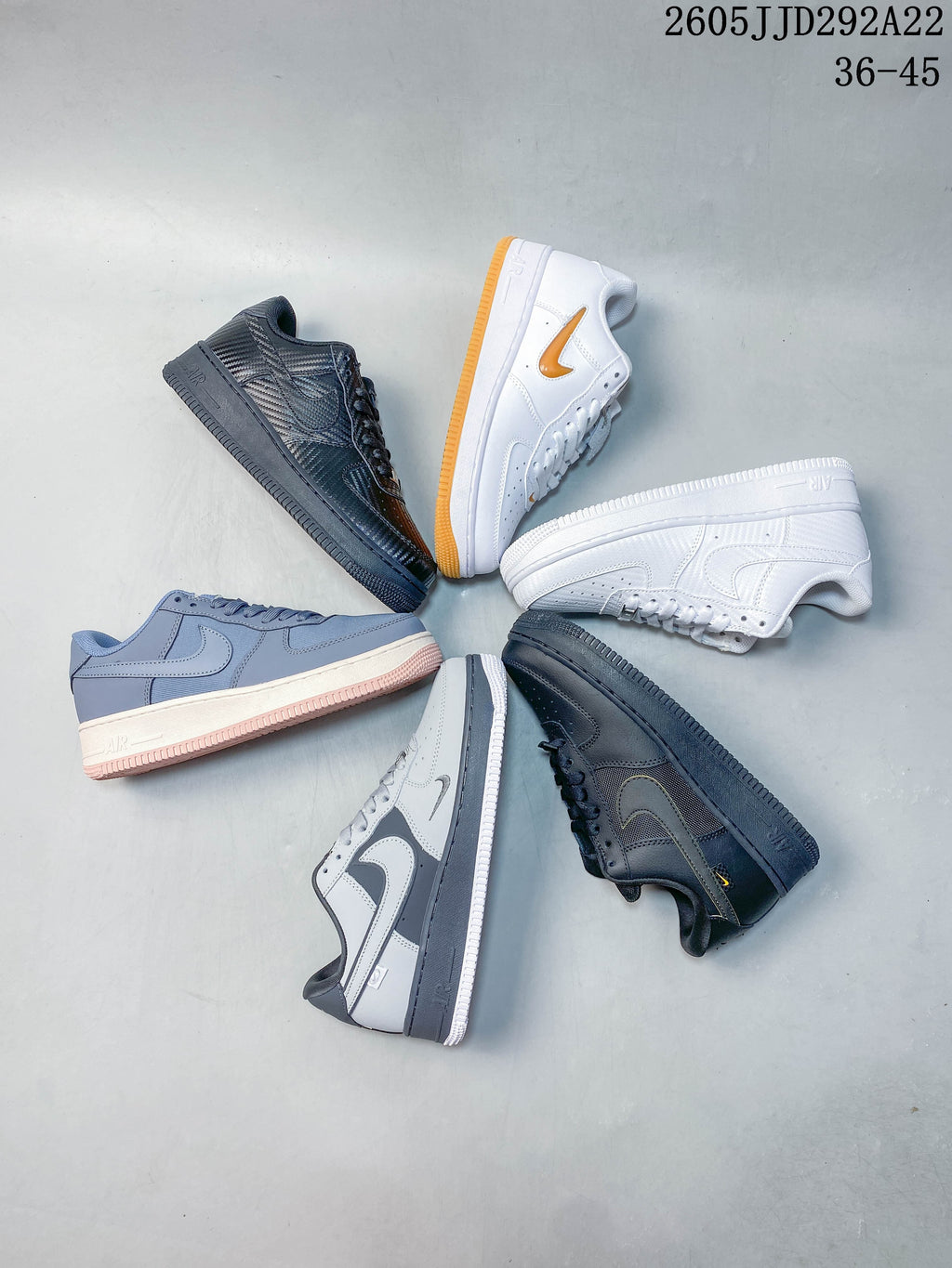 Light gray low-top sneaker with layered panels and a dark gray midsole