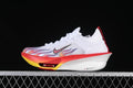Side view of a white Nike running shoe with red, yellow, and multicolor flame-style graphics