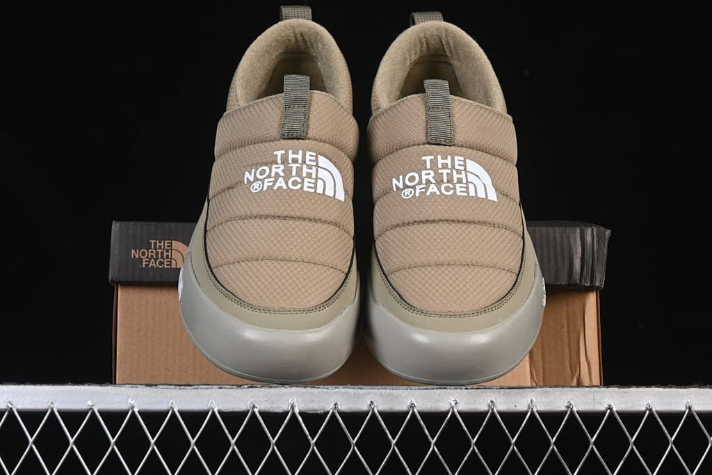 Front view of the pair of khaki slip-on shoes